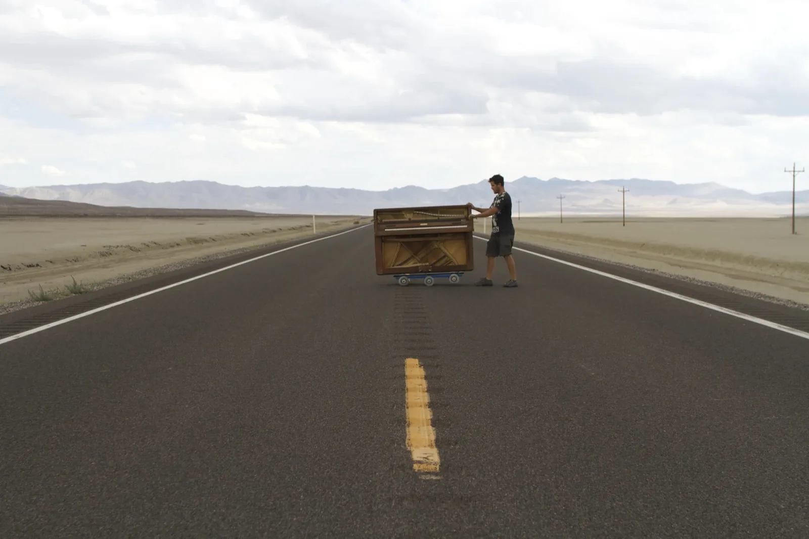Dotan playing piano on a desert highway